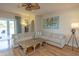 Spacious living room featuring a large sectional sofa, coffee table, and access to a pool area at 1929 24Th Street W Cir, Palmetto, FL 34221