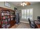 Home office with wood desk, treadmill and built-in bookshelves at 1929 24Th Street W Cir, Palmetto, FL 34221