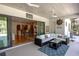 Covered patio with wicker furniture and kitchen view at 1929 24Th Street W Cir, Palmetto, FL 34221