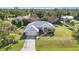 Aerial view of single-Gathering home with large yard and driveway at 23159 Allen Ave, Punta Gorda, FL 33980