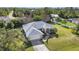 Single-Gathering home with a large yard, driveway, and mature trees at 23159 Allen Ave, Punta Gorda, FL 33980