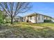 Landscaped backyard with hot tub and screened patio at 23159 Allen Ave, Punta Gorda, FL 33980