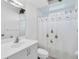 Clean bathroom with white vanity and floral shower curtain at 23159 Allen Ave, Punta Gorda, FL 33980