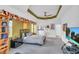 Spacious bedroom with a striped bedspread and large TV at 23159 Allen Ave, Punta Gorda, FL 33980