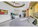 Main bedroom with large TV, striped bedding, and sliding glass doors at 23159 Allen Ave, Punta Gorda, FL 33980