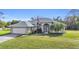 House exterior with a two-car garage and landscaped yard at 23159 Allen Ave, Punta Gorda, FL 33980