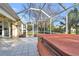 Hot tub on patio with screened enclosure and backyard view at 23159 Allen Ave, Punta Gorda, FL 33980