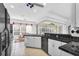 Kitchen with white cabinets, black appliances, and view to screened porch at 23159 Allen Ave, Punta Gorda, FL 33980