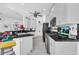 Spacious kitchen with gray cabinets, island, and black appliances at 23159 Allen Ave, Punta Gorda, FL 33980