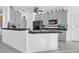 Modern kitchen with gray cabinets, black appliances, and a large island at 23159 Allen Ave, Punta Gorda, FL 33980