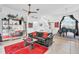 Spacious living room with black leather sofa and red rug at 23159 Allen Ave, Punta Gorda, FL 33980