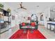 Open living space with leather sofa, red rug, and kitchen views at 23159 Allen Ave, Punta Gorda, FL 33980