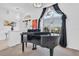 Elegant music room featuring a grand piano and large windows at 23159 Allen Ave, Punta Gorda, FL 33980