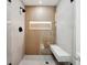 Modern bathroom with a walk-in shower, built-in seat and wood-like wall accents at 2321 Beneva Ter # 2288, Sarasota, FL 34232