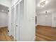 Hallway with light wood floors and white louvered doors at 2321 Beneva Ter # 2288, Sarasota, FL 34232