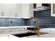 Modern kitchen features a gold faucet and white cabinets at 2321 Beneva Ter # 2288, Sarasota, FL 34232