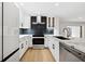 Bright kitchen boasts white cabinets, dark tile backsplash, and stainless steel appliances at 2321 Beneva Ter # 2288, Sarasota, FL 34232