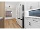 Kitchen with white cabinets and hardwood floors at 2321 Beneva Ter # 2288, Sarasota, FL 34232