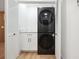 Laundry closet with stackable washer and dryer, and white shaker cabinets at 2321 Beneva Ter # 2288, Sarasota, FL 34232