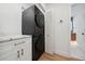 Laundry room with stackable washer and dryer and white cabinets at 2321 Beneva Ter # 2288, Sarasota, FL 34232