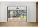 Bright sunroom with wood floors and sliding glass doors to a balcony at 2321 Beneva Ter # 2288, Sarasota, FL 34232