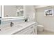 Modern bathroom with white cabinets and blue mosaic tile at 2350 Via Venice, Punta Gorda, FL 33950