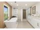 Modern bathroom with soaking tub, walk-in shower, and double vanity at 2350 Via Venice, Punta Gorda, FL 33950