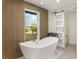 Spa-like bathroom featuring a freestanding tub and barn door at 2350 Via Venice, Punta Gorda, FL 33950