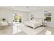 Bright bedroom with a queen-size bed, two chairs, and access to patio at 2350 Via Venice, Punta Gorda, FL 33950
