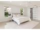 Bright bedroom with a queen-size bed, and a barn door leading to a spacious closet at 2350 Via Venice, Punta Gorda, FL 33950