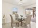 Bright dining room with glass table, four chairs, and access to backyard at 2350 Via Venice, Punta Gorda, FL 33950