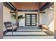 Covered entry with modern double doors and sitting area at 2350 Via Venice, Punta Gorda, FL 33950