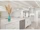 Modern white kitchen with center island, stainless steel appliances, and quartz countertops at 2350 Via Venice, Punta Gorda, FL 33950