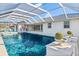 Inviting pool area with a covered patio and luxurious landscaping at 2350 Via Venice, Punta Gorda, FL 33950