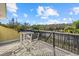 Outdoor balcony overlooking a lush landscape with a table and two chairs for relaxing and enjoying the view at 2500 Jamaica St, Sarasota, FL 34231