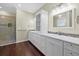 Bathroom with marble countertops, double sinks, and glass shower at 2500 Jamaica St, Sarasota, FL 34231