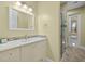 Bathroom with a single sink vanity and glass-enclosed shower at 2500 Jamaica St, Sarasota, FL 34231