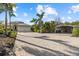 Long paved driveway leading to the three-car garage and a detached covered parking area at 2500 Jamaica St, Sarasota, FL 34231