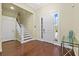 Elegant foyer with hardwood floors, staircase, and bright entryway with sidelight windows at 2500 Jamaica St, Sarasota, FL 34231