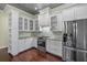Bright kitchen featuring white cabinetry, stainless steel appliances, and decorative backsplash at 2500 Jamaica St, Sarasota, FL 34231