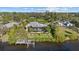 Waterfront home with a screened-in porch, private dock, and lush landscaping, perfect for enjoying the outdoors at 2500 Jamaica St, Sarasota, FL 34231