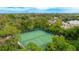 Aerial view of two tennis courts surrounded by lush tropical landscaping at 307 Timberlake Dr # 307, Bradenton, FL 34210