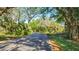 Paved road winding through lush landscaping with mature trees at 307 Timberlake Dr # 307, Bradenton, FL 34210