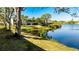 Landscaped grounds with lake view and trees at 307 Timberlake Dr # 307, Bradenton, FL 34210