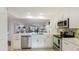 Open concept kitchen with island, stainless steel appliances and view to living room at 307 Timberlake Dr # 307, Bradenton, FL 34210