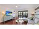 Living room features hardwood floors, sectional sofa, and sliding glass doors leading to a patio at 307 Timberlake Dr # 307, Bradenton, FL 34210
