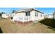 Spacious deck with white railings overlooks a grassy backyard at 3214 Pink Oak Ter, Sarasota, FL 34237