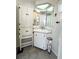 Bathroom with corner vanity and white storage cabinet at 3214 Pink Oak Ter, Sarasota, FL 34237