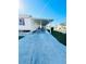 Covered carport with speckled concrete flooring at 3214 Pink Oak Ter, Sarasota, FL 34237
