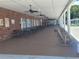 Relaxing outdoor patio area with tables, chairs, and ceiling fans at 3214 Pink Oak Ter, Sarasota, FL 34237